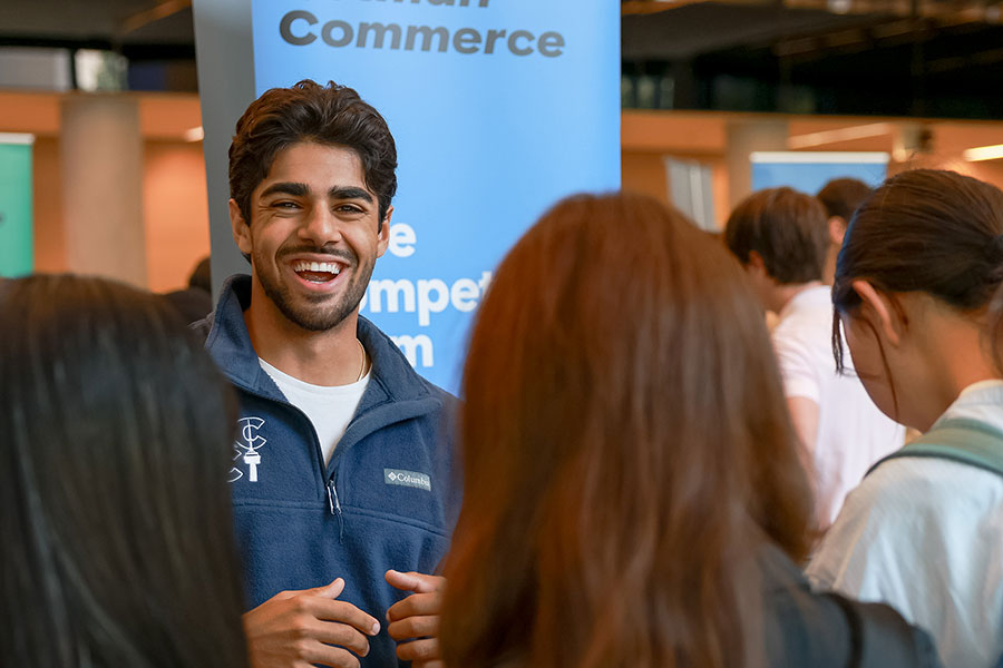 Rotman Commerce student speaking with a group of students during orientation.