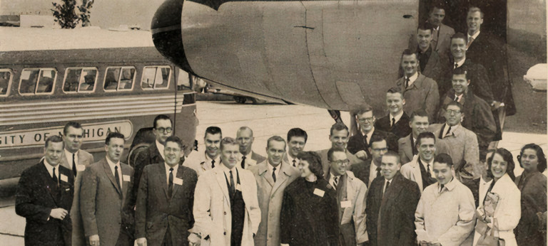 students in front of a plane